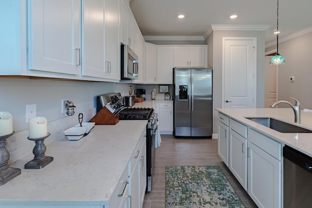 745 SE Bloomfield Rd, Port Saint Lucie, FL 34984 - kitchen with appliances with stainless steel finishes, a sink, crown molding, white cabinetry, and recessed lighting