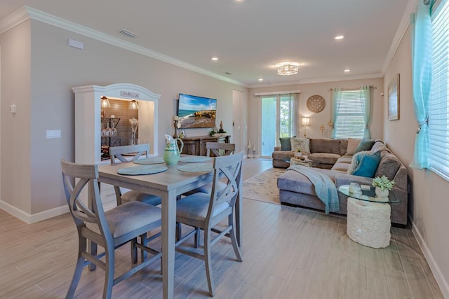745 SE Bloomfield Rd, Port Saint Lucie, FL 34984 - dining room featuring baseboards, light wood finished floors, recessed lighting, and crown molding