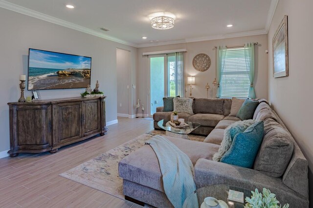 745 SE Bloomfield Rd, Port Saint Lucie, FL 34984 - living area featuring plenty of natural light, light wood-type flooring, baseboards, recessed lighting, and ornamental molding