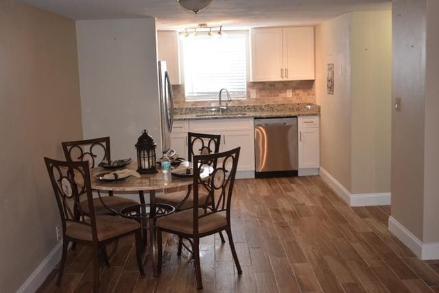 dining area featuring wood finished floors and baseboards