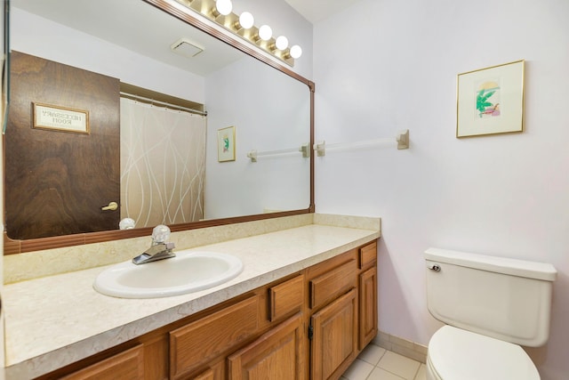 full bathroom featuring toilet, vanity, and tile patterned floors