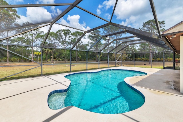 outdoor pool with a patio, a lawn, and a lanai