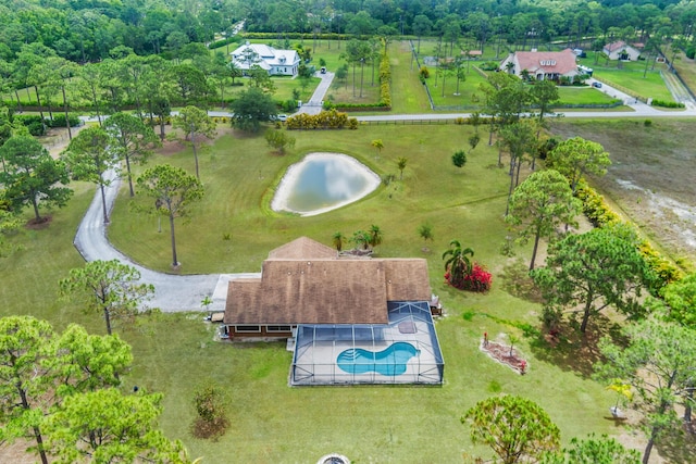 drone / aerial view of a pool area and a large body of water