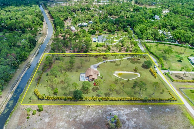 aerial view of property and surrounding area with property parcel outlined