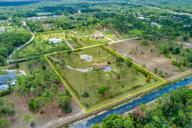 aerial overview of property's location with property boundaries highlighted and a large body of water