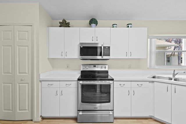 6527 Alheli, Fort Pierce, FL 34951 - kitchen featuring stainless steel appliances, a sink, light countertops, and white cabinets