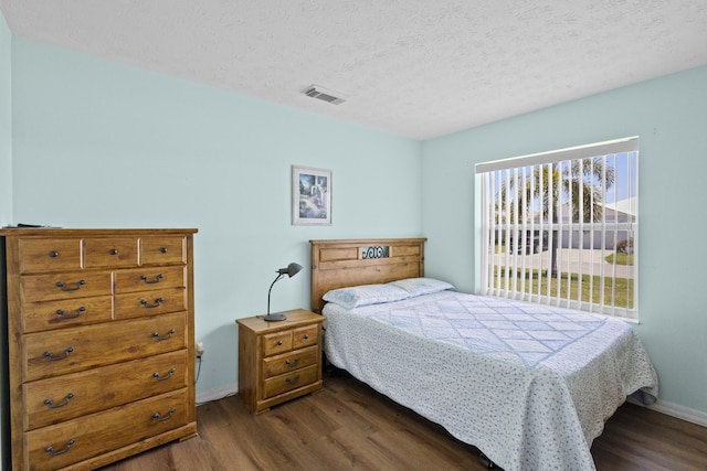 6527 Alheli, Fort Pierce, FL 34951 - bedroom featuring dark wood-style floors, baseboards, and a textured ceiling