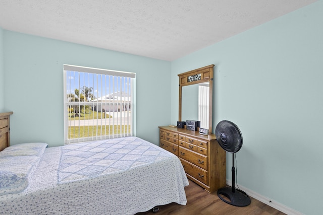 6527 Alheli, Fort Pierce, FL 34951 - bedroom featuring dark wood finished floors, baseboards, and a textured ceiling