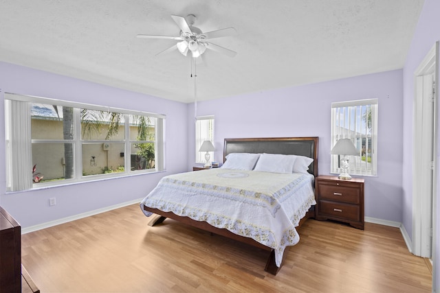 6527 Alheli, Fort Pierce, FL 34951 - bedroom featuring wood finished floors, multiple windows, a textured ceiling, and baseboards