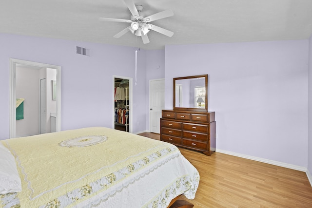 6527 Alheli, Fort Pierce, FL 34951 - bedroom featuring baseboards, light wood-style floors, a closet, a spacious closet, and connected bathroom
