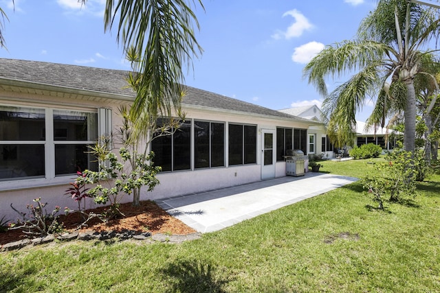 6527 Alheli, Fort Pierce, FL 34951 - rear view of house featuring a lawn, a patio, and a shingled roof