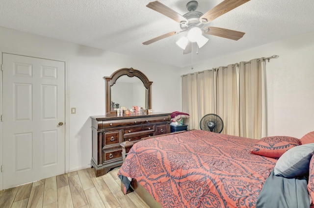 555 SW Sara Blvd, Port Saint Lucie, FL 34953 - bedroom with a textured ceiling, light wood-style floors, and a ceiling fan