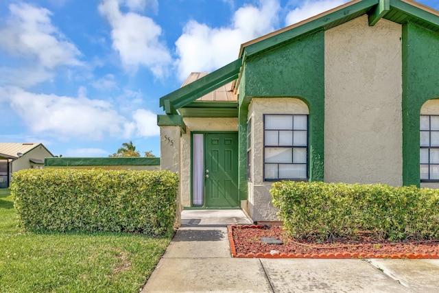 555 SW Sara Blvd, Port Saint Lucie, FL 34953 - doorway to property featuring stucco siding