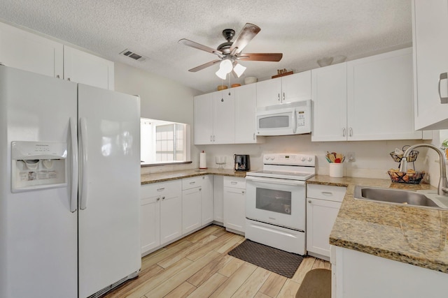 555 SW Sara Blvd, Port Saint Lucie, FL 34953 - kitchen featuring white appliances, a sink, a ceiling fan, white cabinetry, and a textured ceiling