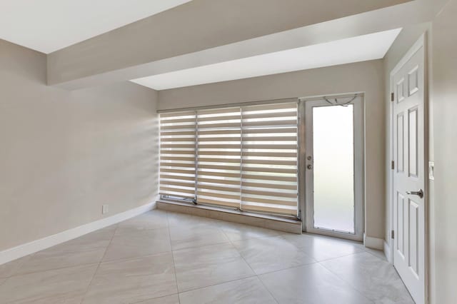 1131 Violet Ter Unit 104, Delray Beach, FL 33445 - tiled empty room with baseboards