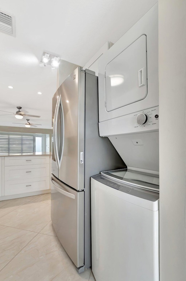 1131 Violet Ter Unit 104, Delray Beach, FL 33445 - washroom featuring a ceiling fan and stacked washing machine and dryer