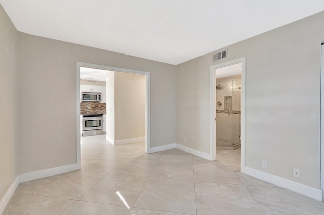 1131 Violet Ter Unit 104, Delray Beach, FL 33445 - spare room with baseboards and a ceiling fan