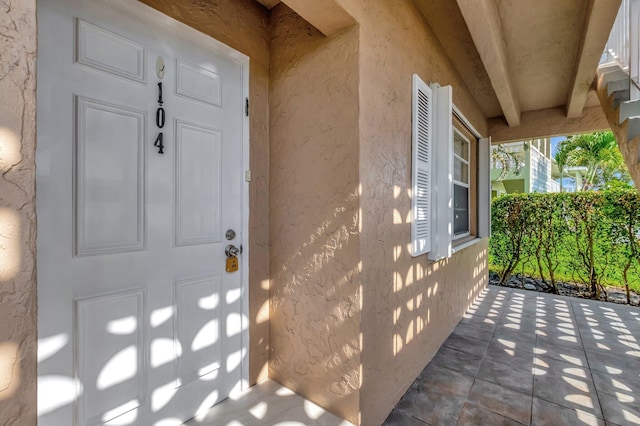 1131 Violet Ter Unit 104, Delray Beach, FL 33445 - doorway to property featuring stucco siding