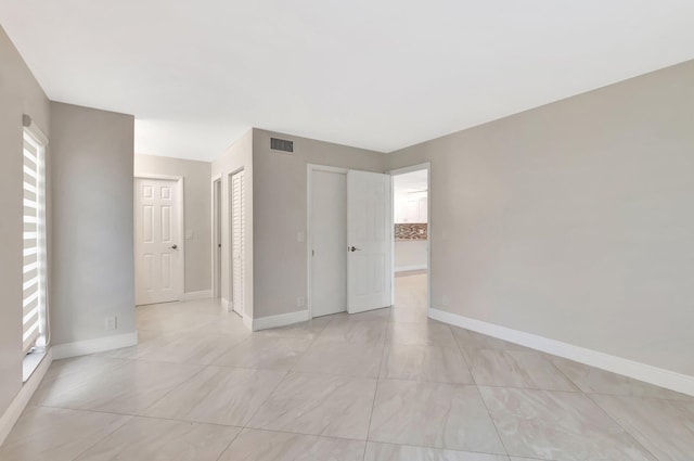 1131 Violet Ter Unit 104, Delray Beach, FL 33445 - spare room with baseboards and light tile patterned floors
