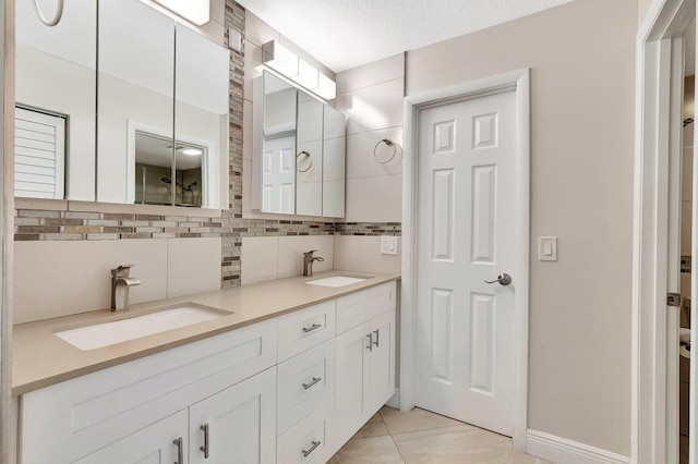 1131 Violet Ter Unit 104, Delray Beach, FL 33445 - bathroom with tasteful backsplash, double vanity, and baseboards