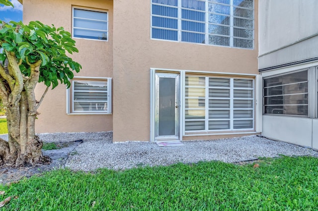 1131 Violet Ter Unit 104, Delray Beach, FL 33445 - rear view of property with stucco siding