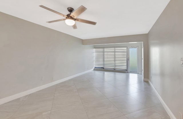 1131 Violet Ter Unit 104, Delray Beach, FL 33445 - empty room featuring baseboards, ceiling fan, and light tile patterned flooring
