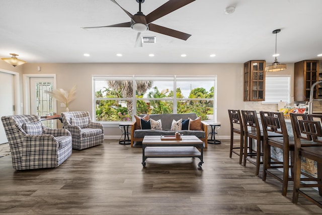 living area featuring recessed lighting, a ceiling fan, dark wood-type flooring, and baseboards