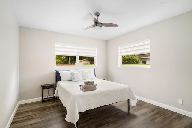 bedroom with baseboards, dark wood-style floors, and ceiling fan