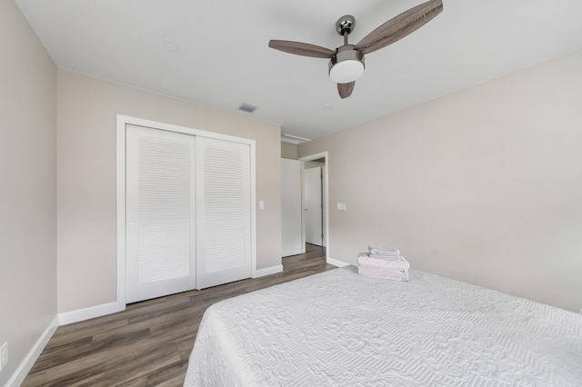 bedroom featuring wood finished floors, a closet, and baseboards