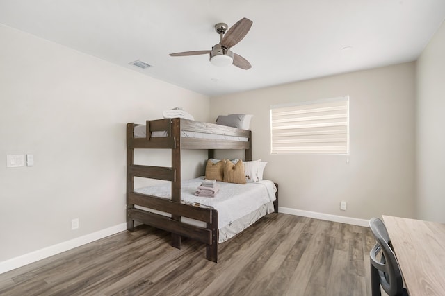 bedroom with wood finished floors, baseboards, and a ceiling fan