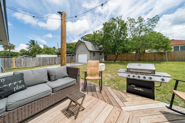 wooden terrace featuring an outdoor living space, an outdoor structure, grilling area, and a garage