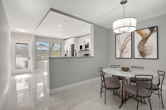 2202 Lucaya Bnd Unit G2, Coconut Creek, FL 33066 - dining space with baseboards, recessed lighting, and light marble finish flooring