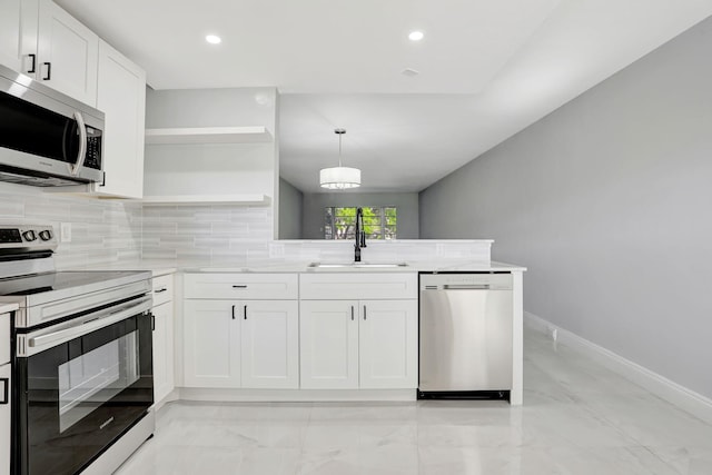 2202 Lucaya Bnd Unit G2, Coconut Creek, FL 33066 - kitchen with appliances with stainless steel finishes, a sink, a peninsula, backsplash, and light marble finish floors
