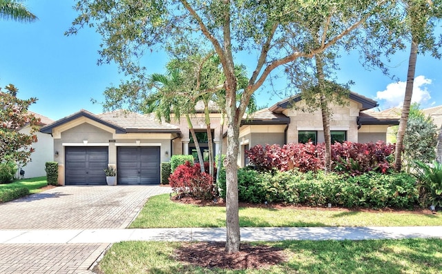 9288 Tropez Ln, Delray Beach, FL 33446 - ranch-style home with an attached garage, decorative driveway, and stucco siding