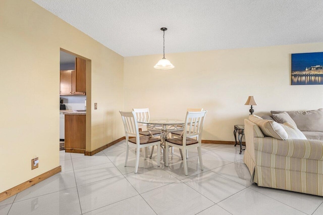 9101 W Sample Rd Unit 805, Coral Springs, FL 33065 - dining room with baseboards, a textured ceiling, and light tile patterned flooring