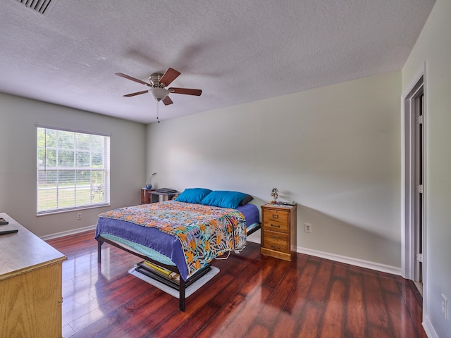537 SW Hiawatha St, Port Saint Lucie, FL 34953 - bedroom featuring wood finished floors, baseboards, a textured ceiling, and ceiling fan