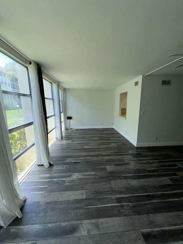 851 Three Islands Blvd Unit 102, Hallandale Beach, FL 33009 - spare room with dark wood-style flooring and baseboards