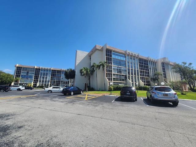 851 Three Islands Blvd Unit 102, Hallandale Beach, FL 33009 - view of apartment building / complex featuring uncovered parking