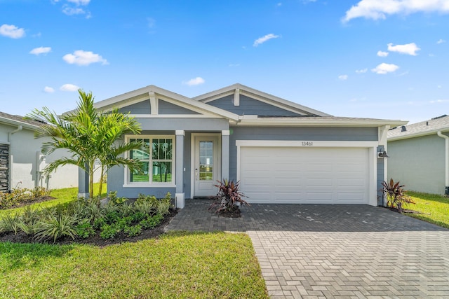 13461 SW Bally Dr, Port Saint Lucie, FL 34987 - view of front of house featuring decorative driveway, a garage, stucco siding, and a front lawn