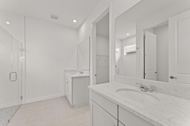 13461 SW Bally Dr, Port Saint Lucie, FL 34987 - full bath with a shower stall, a spacious closet, two vanities, recessed lighting, and baseboards