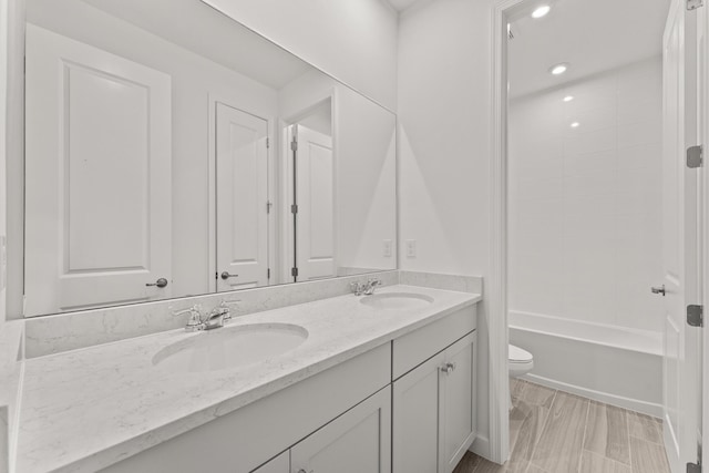 13461 SW Bally Dr, Port Saint Lucie, FL 34987 - full bath featuring toilet, double vanity, recessed lighting, and bathing tub / shower combination