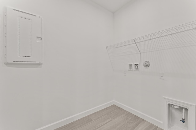 13461 SW Bally Dr, Port Saint Lucie, FL 34987 - washroom with electric dryer hookup, baseboards, gas dryer hookup, washer hookup, and light wood-style flooring