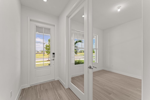 13461 SW Bally Dr, Port Saint Lucie, FL 34987 - doorway to outside with light wood-type flooring, baseboards, french doors, and recessed lighting