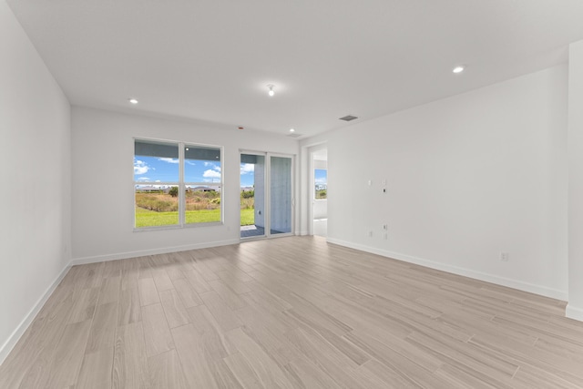 13461 SW Bally Dr, Port Saint Lucie, FL 34987 - empty room featuring light wood-style floors, recessed lighting, and baseboards