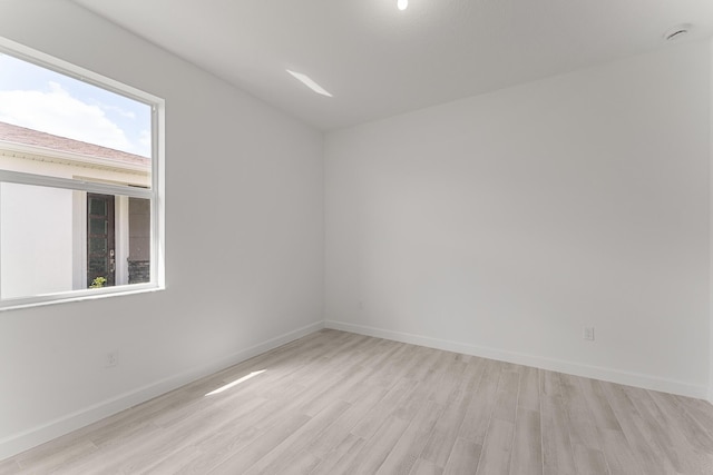13445 SW Bally Dr, Port Saint Lucie, FL 34987 - spare room with light wood finished floors, plenty of natural light, and baseboards
