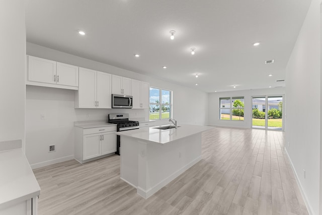 13445 SW Bally Dr, Port Saint Lucie, FL 34987 - kitchen with appliances with stainless steel finishes, a sink, white cabinets, and recessed lighting