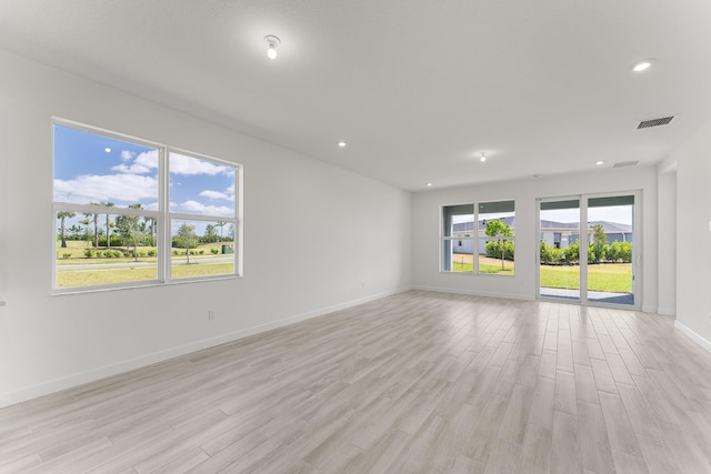 13445 SW Bally Dr, Port Saint Lucie, FL 34987 - empty room featuring light wood-style flooring, recessed lighting, and baseboards