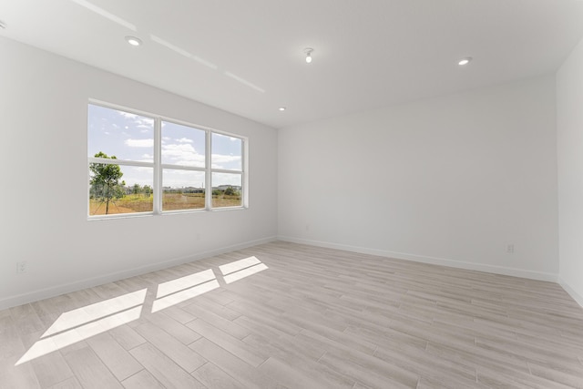 13445 SW Bally Dr, Port Saint Lucie, FL 34987 - empty room with light wood-type flooring, baseboards, and recessed lighting