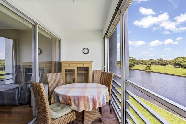 sunroom / solarium with a water view