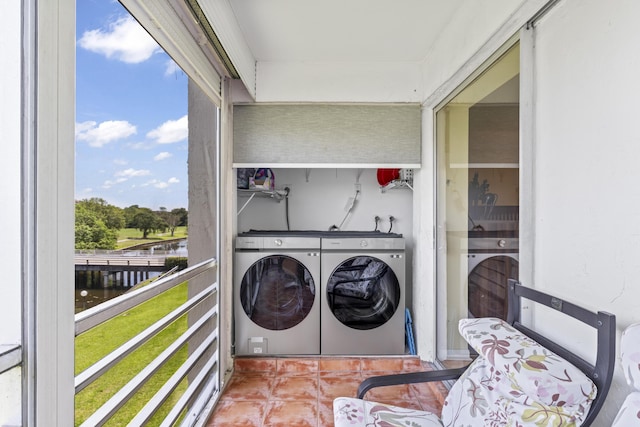 laundry area with a water view and separate washer and dryer